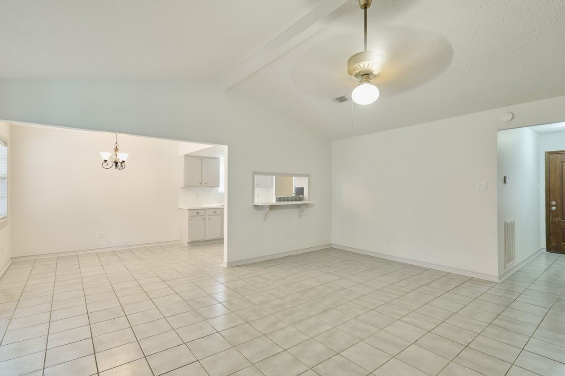 619 Pinewood Drive Conroe, TX 77385 - Photo 13 of 44 an empty room with chandelier fan and windows