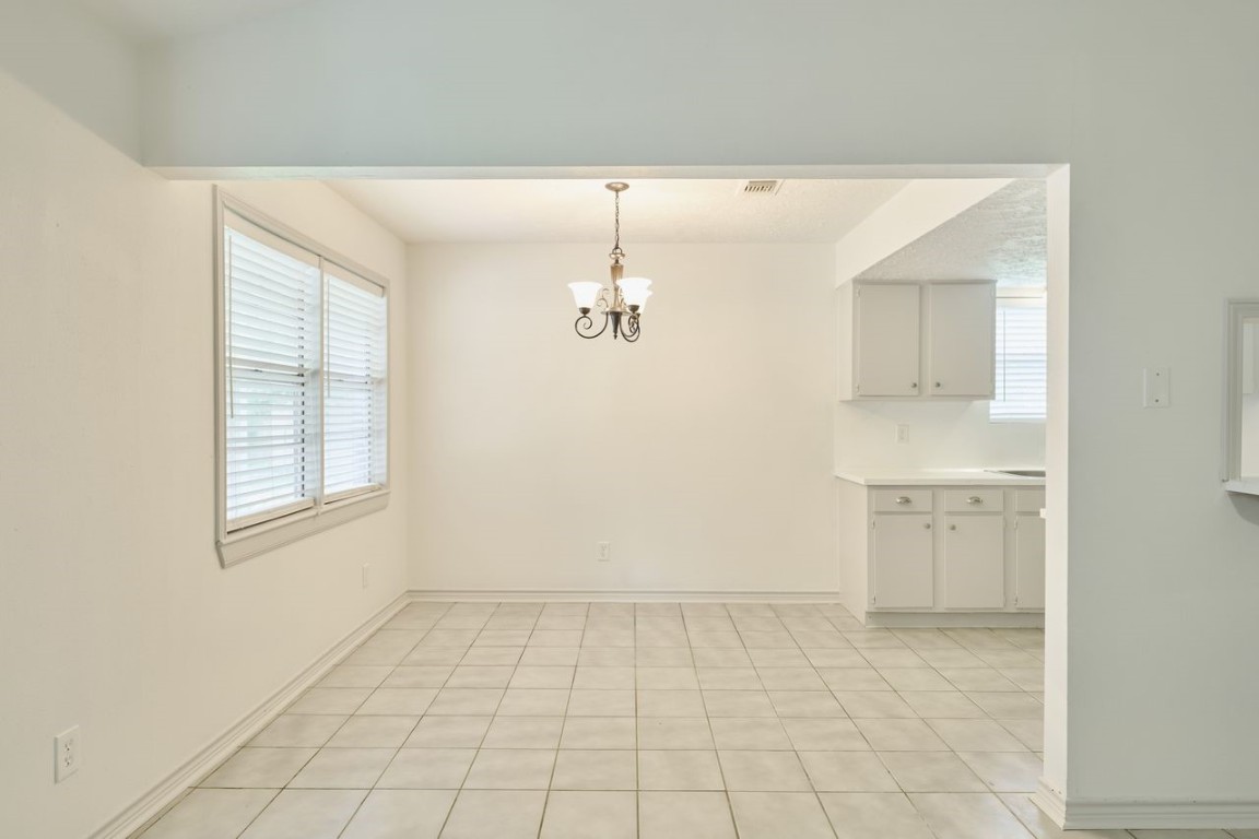 619 Pinewood Drive Conroe, TX 77385 - Photo 16 of 44 an empty room with windows and cabinet