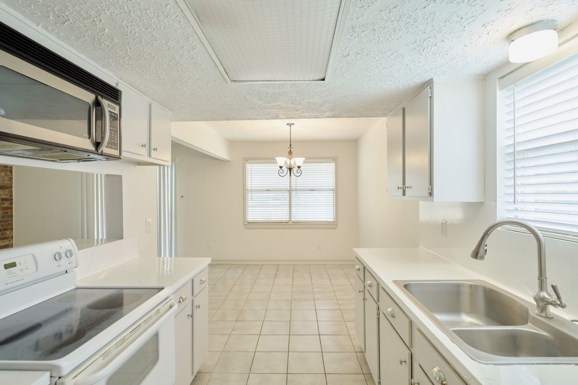 619 Pinewood Drive Conroe, TX 77385 - Photo 20 of 44 a kitchen with a sink cabinets and window