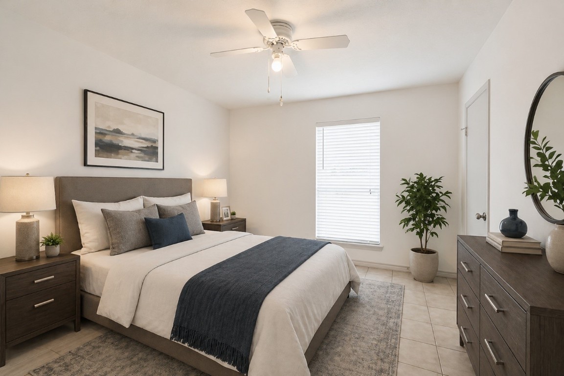 619 Pinewood Drive Conroe, TX 77385 - Photo 23 of 44 a bedroom with a large bed and a potted plant