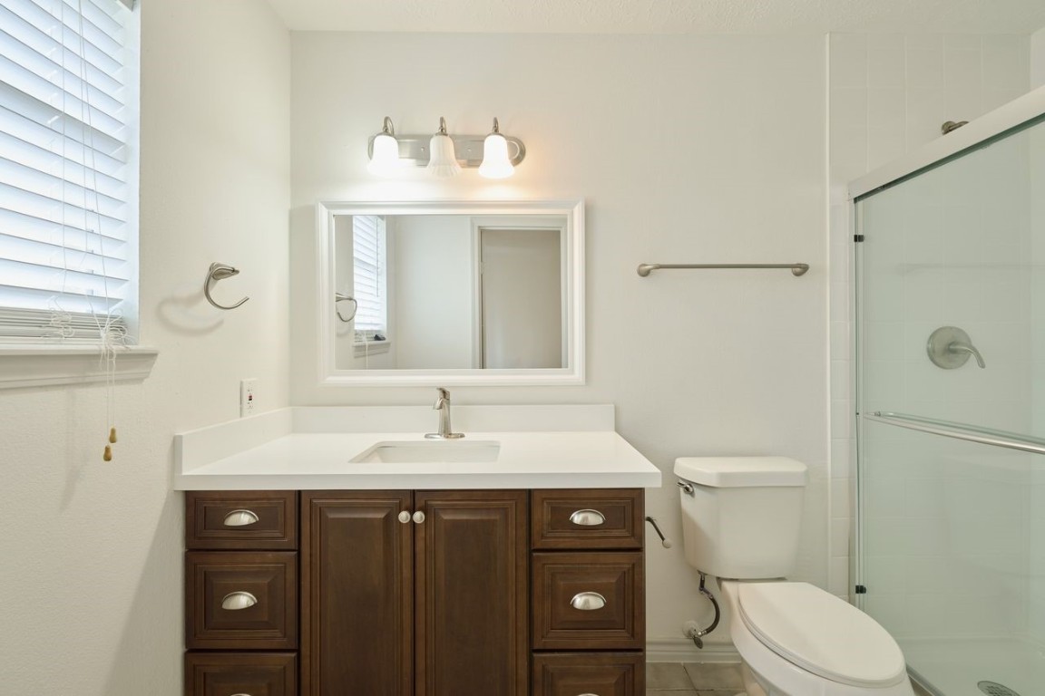 619 Pinewood Drive Conroe, TX 77385 - Photo 33 of 44 a bathroom with a sink toilet and mirror