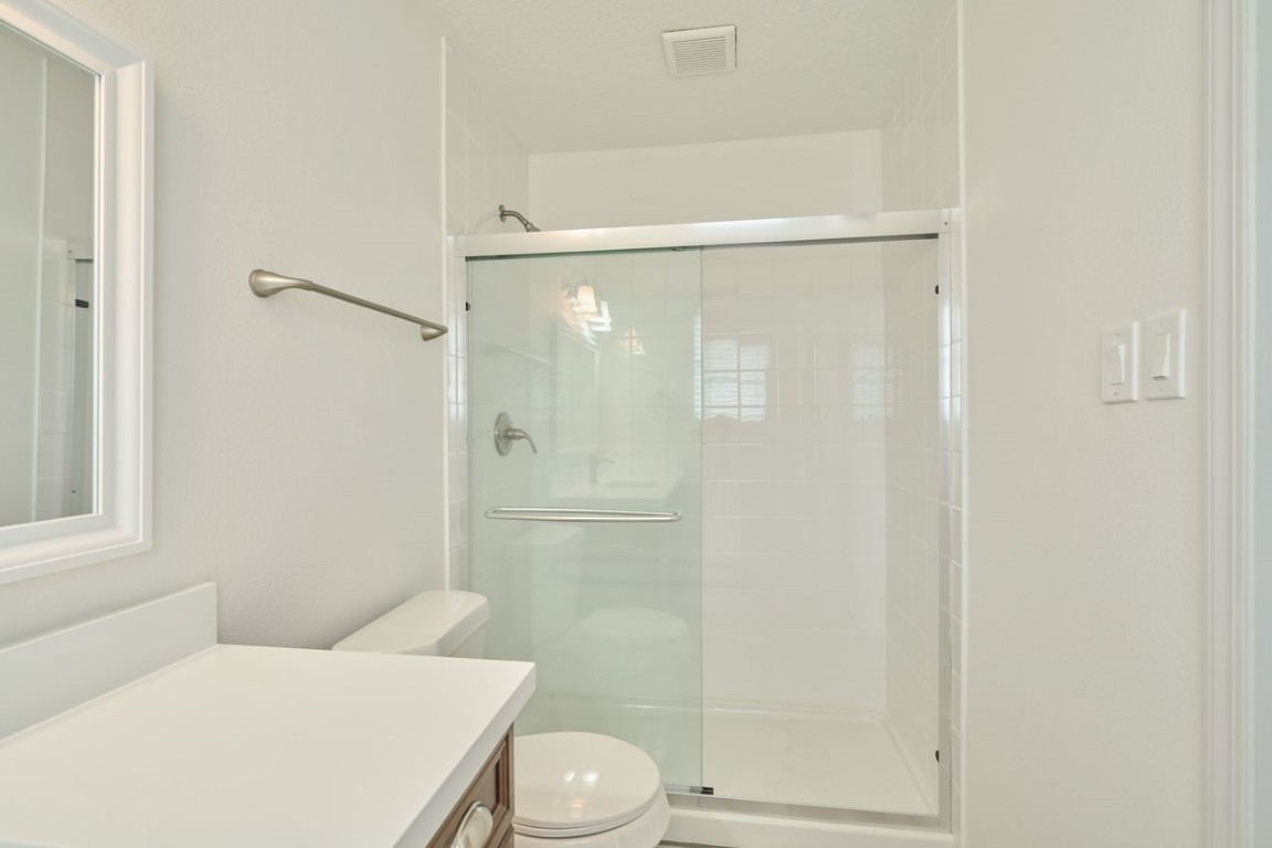 619 Pinewood Drive Conroe, TX 77385 - Photo 34 of 44 a bathroom with a shower and a toilet