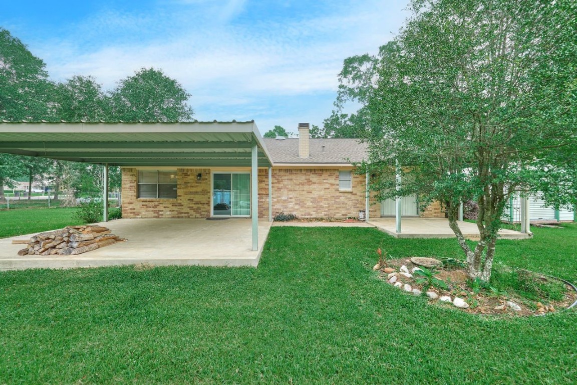 619 Pinewood Drive Conroe, TX 77385 - Photo 37 of 44 a view of house with backyard outdoor seating and green space