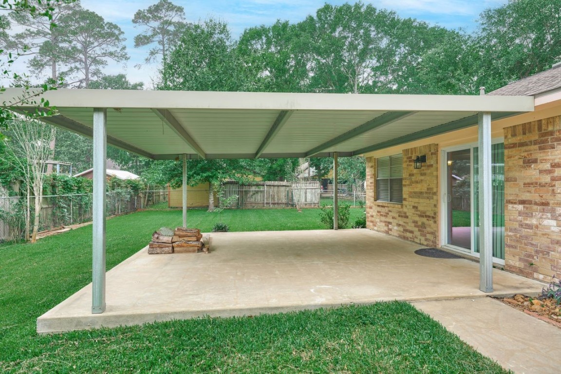 619 Pinewood Drive Conroe, TX 77385 - Photo 41 of 44 a view of a house with backyard and porch