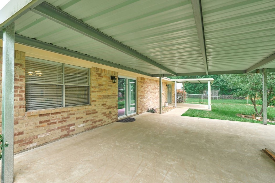 619 Pinewood Drive Conroe, TX 77385 - Photo 43 of 44 a view of a house with backyard and porch