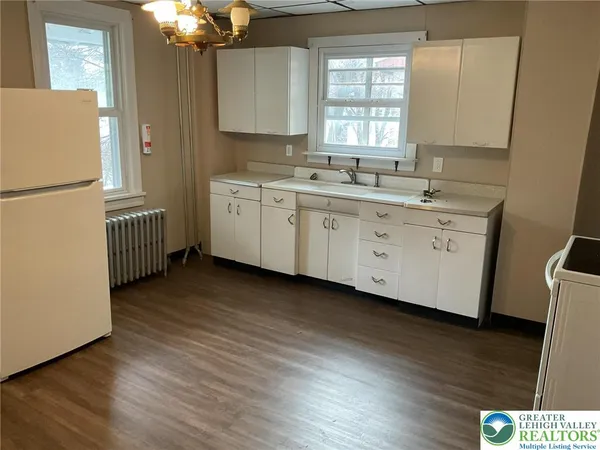 a kitchen with sink cabinets and wooden floor
