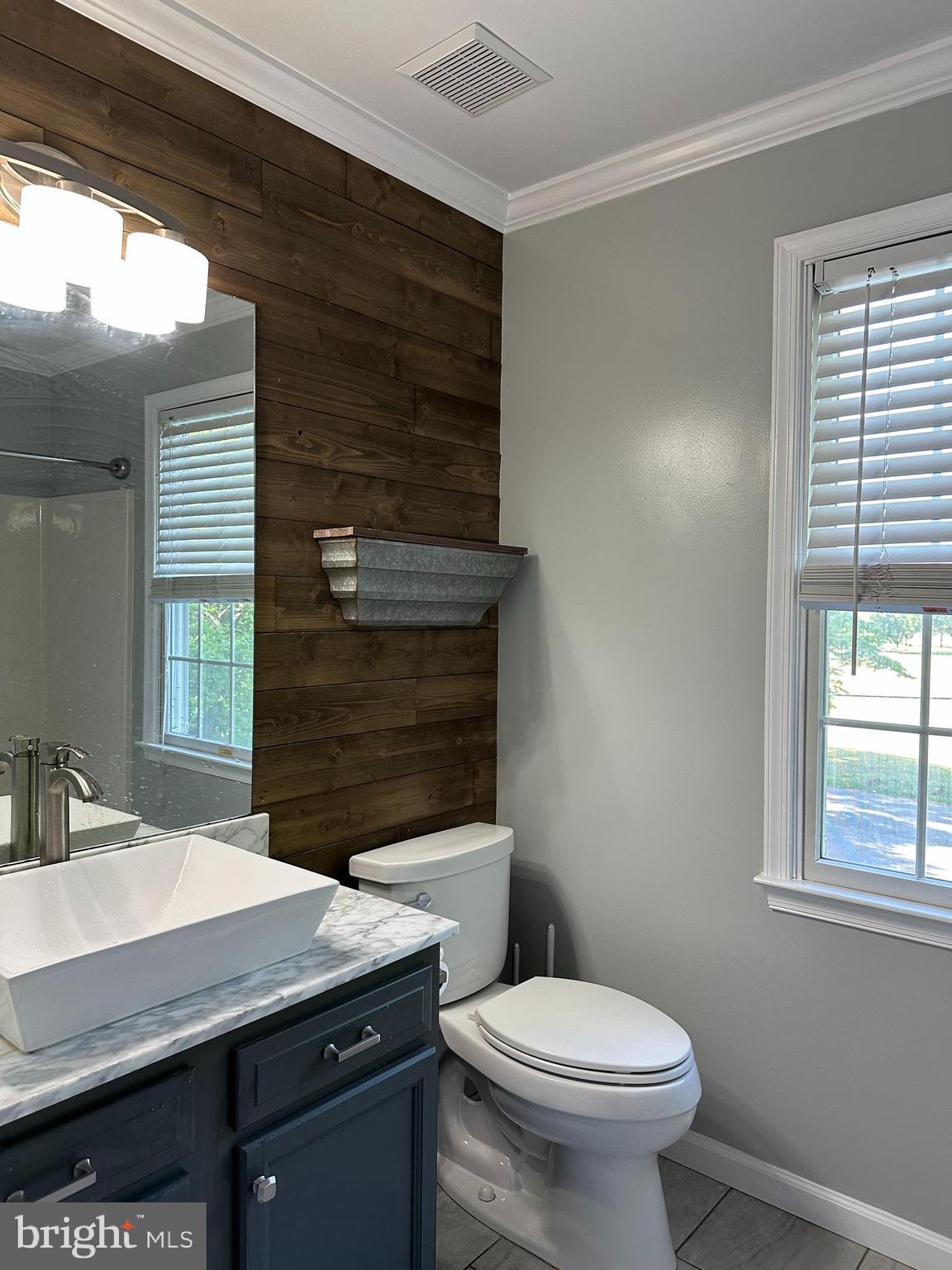 324 Jennings Road Severna Park, MD 21146 - Photo 19 of 28 a bathroom with a sink a toilet a mirror and window