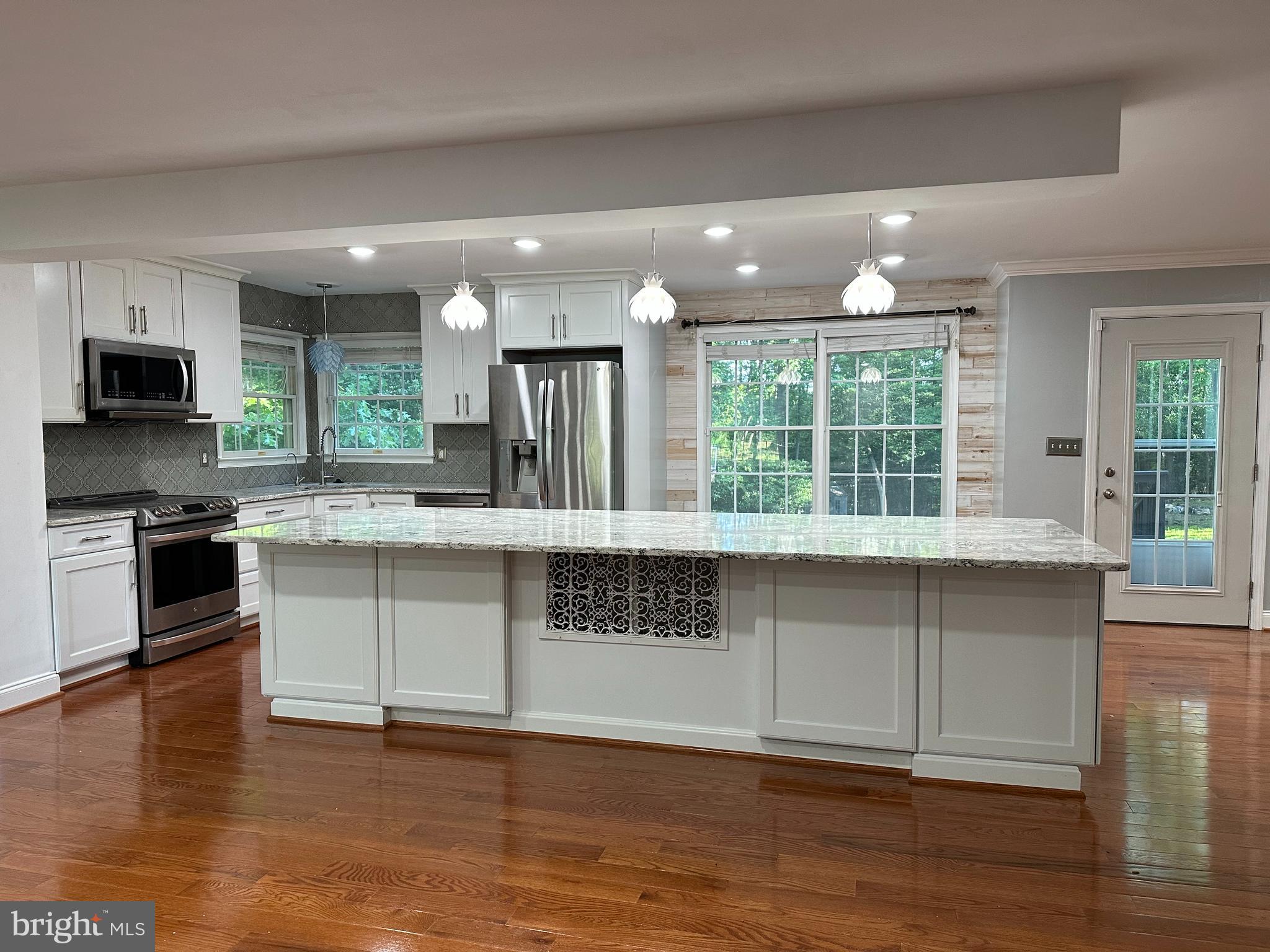 324 Jennings Road Severna Park, MD 21146 - Photo 6 of 28 a kitchen with granite countertop a stove and a wooden floors