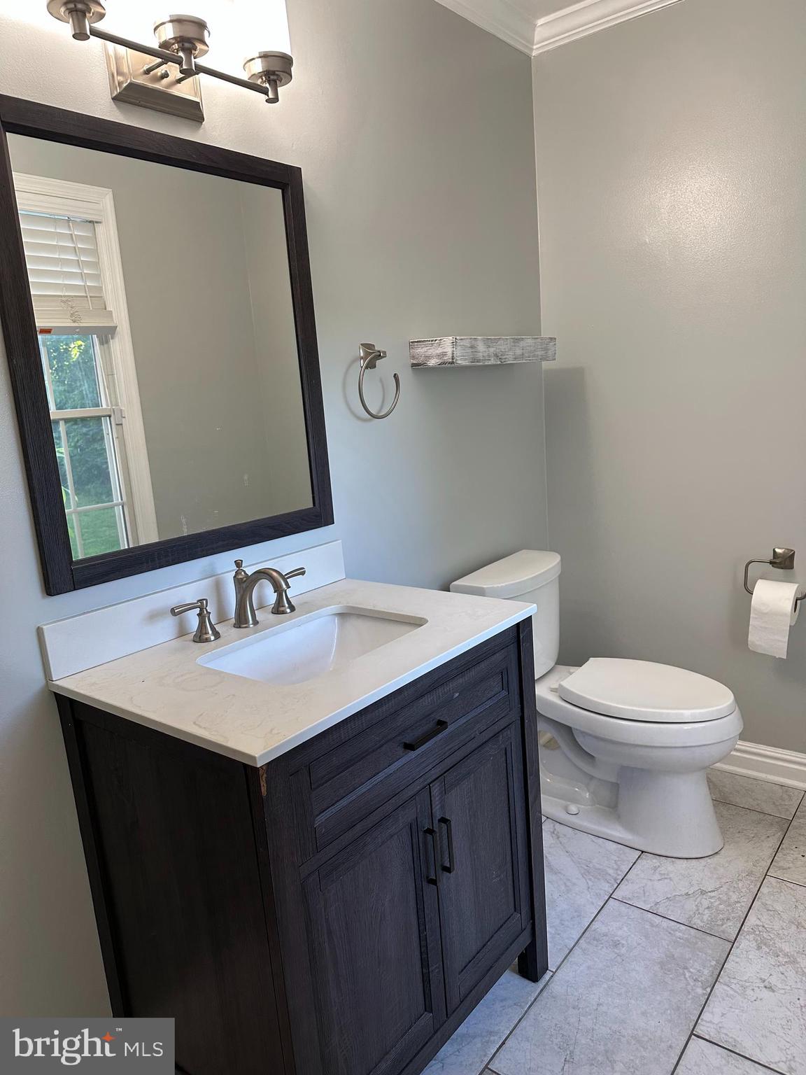 324 Jennings Road Severna Park, MD 21146 - Photo 9 of 28 a bathroom with a toilet a sink a mirror and vanity