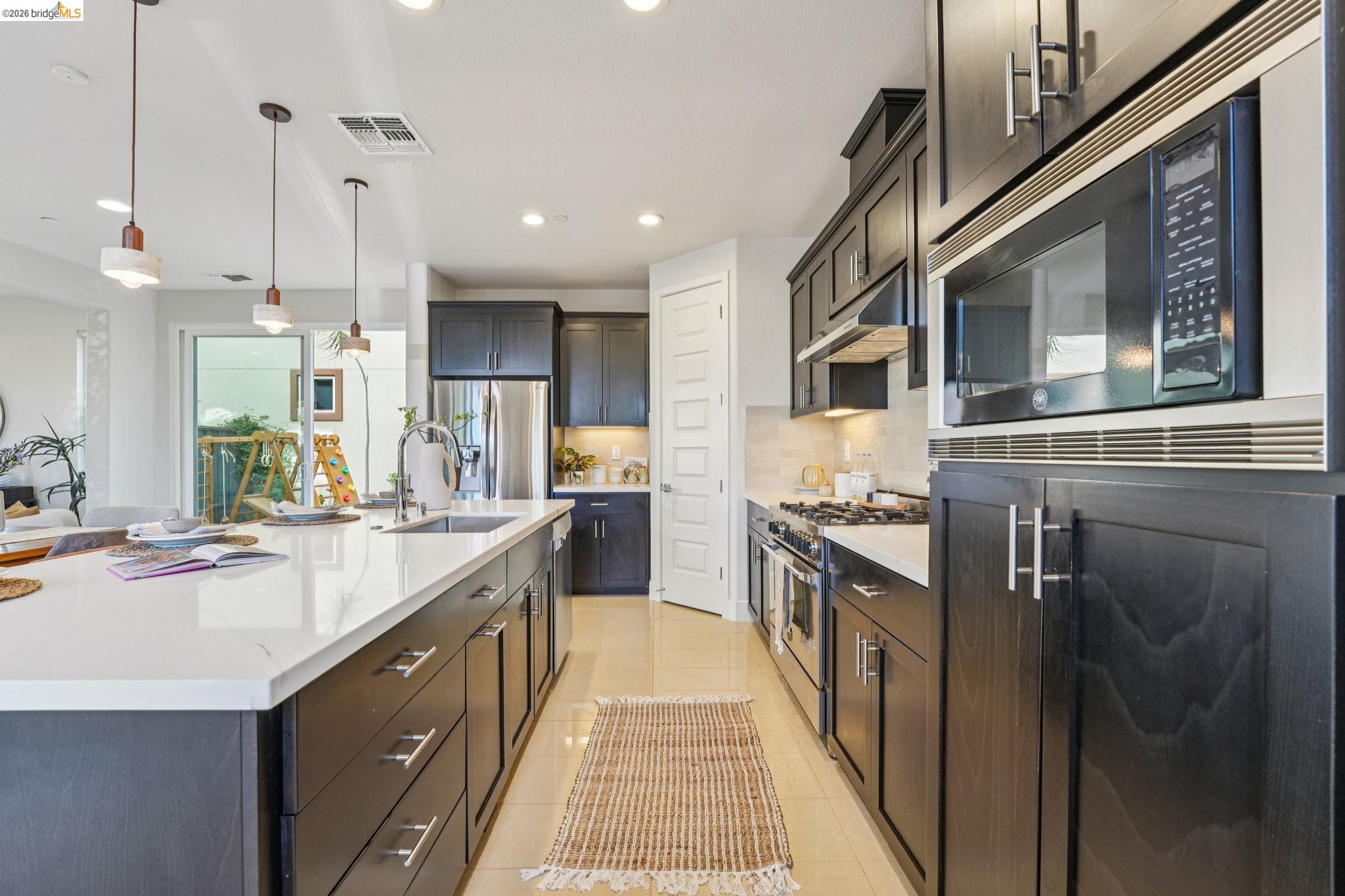 2770 Bette Street Alameda, CA 94501 - Photo 17 of 60 a kitchen with stainless steel appliances granite countertop a sink and stove
