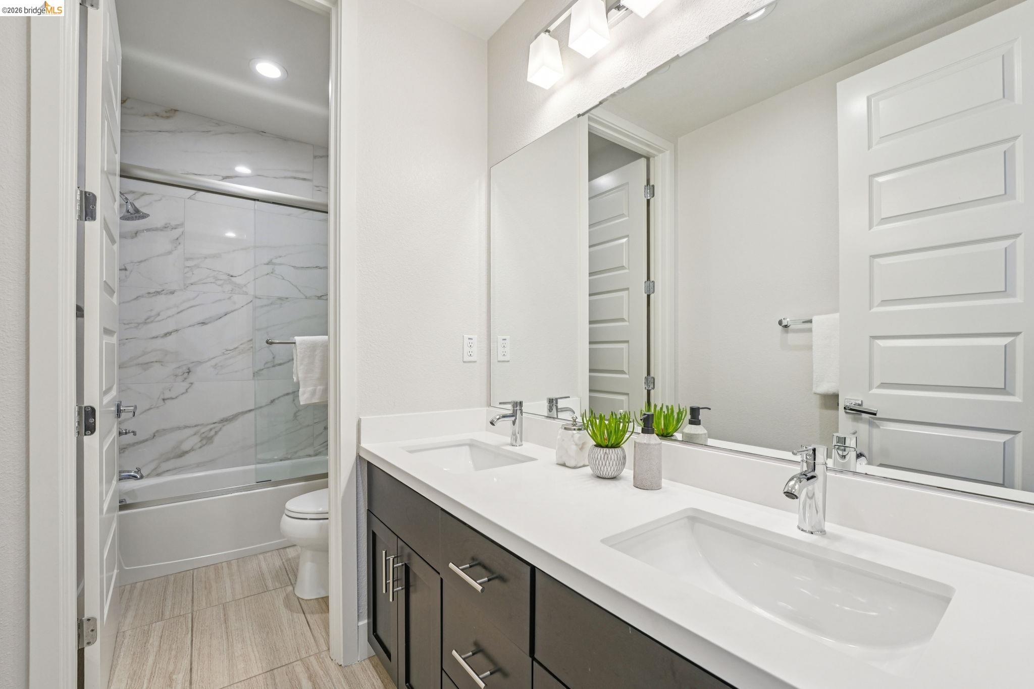 2770 Bette Street Alameda, CA 94501 - Photo 38 of 60 a bathroom with a double vanity sink toilet and shower