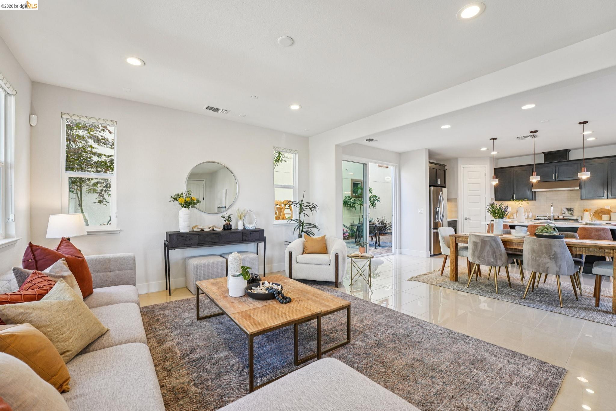 2770 Bette Street Alameda, CA 94501 - Photo 6 of 60 a living room with furniture a rug kitchen view and a large window