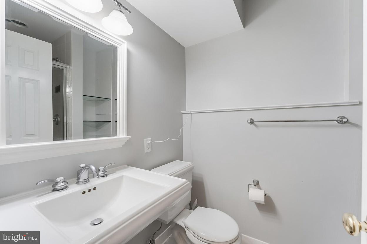 11621 Sourwood Lane Reston, VA 20191 - Photo 23 of 26 a bathroom with a sink mirror and toilet