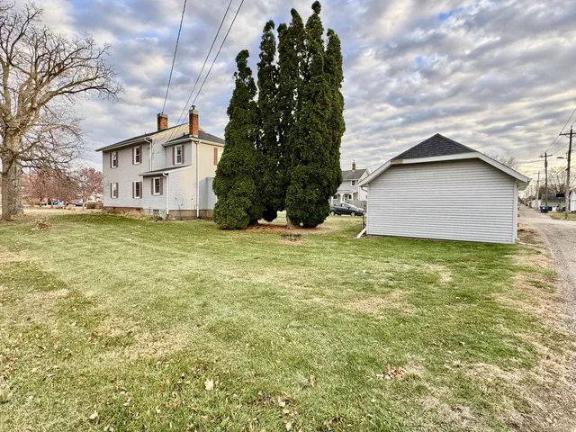 a view of a house with a yard and garage