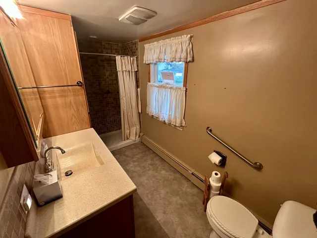 a bathroom with a sink toilet and shower