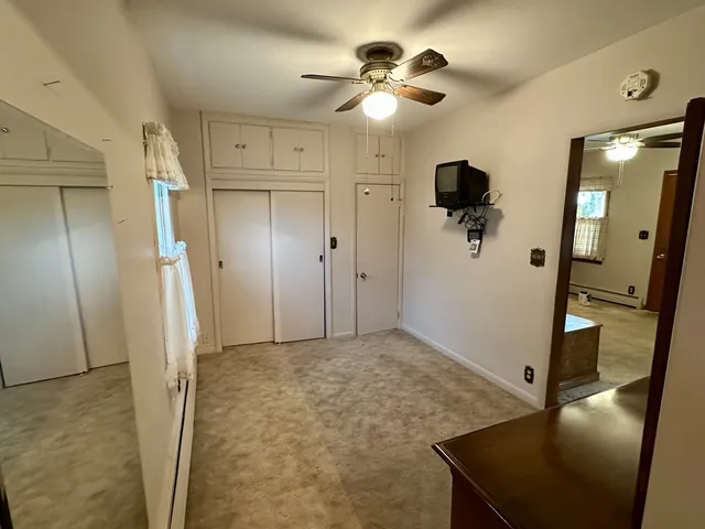 a view of a hallway with a chandelier fan