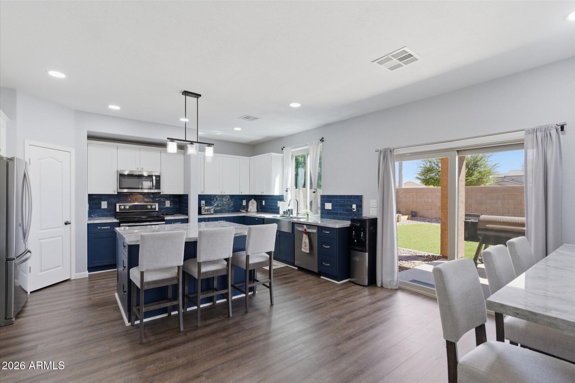 21915 Dietz Drive Maricopa, AZ 85138 - Photo 6 of 31 a kitchen with a table and chairs in it