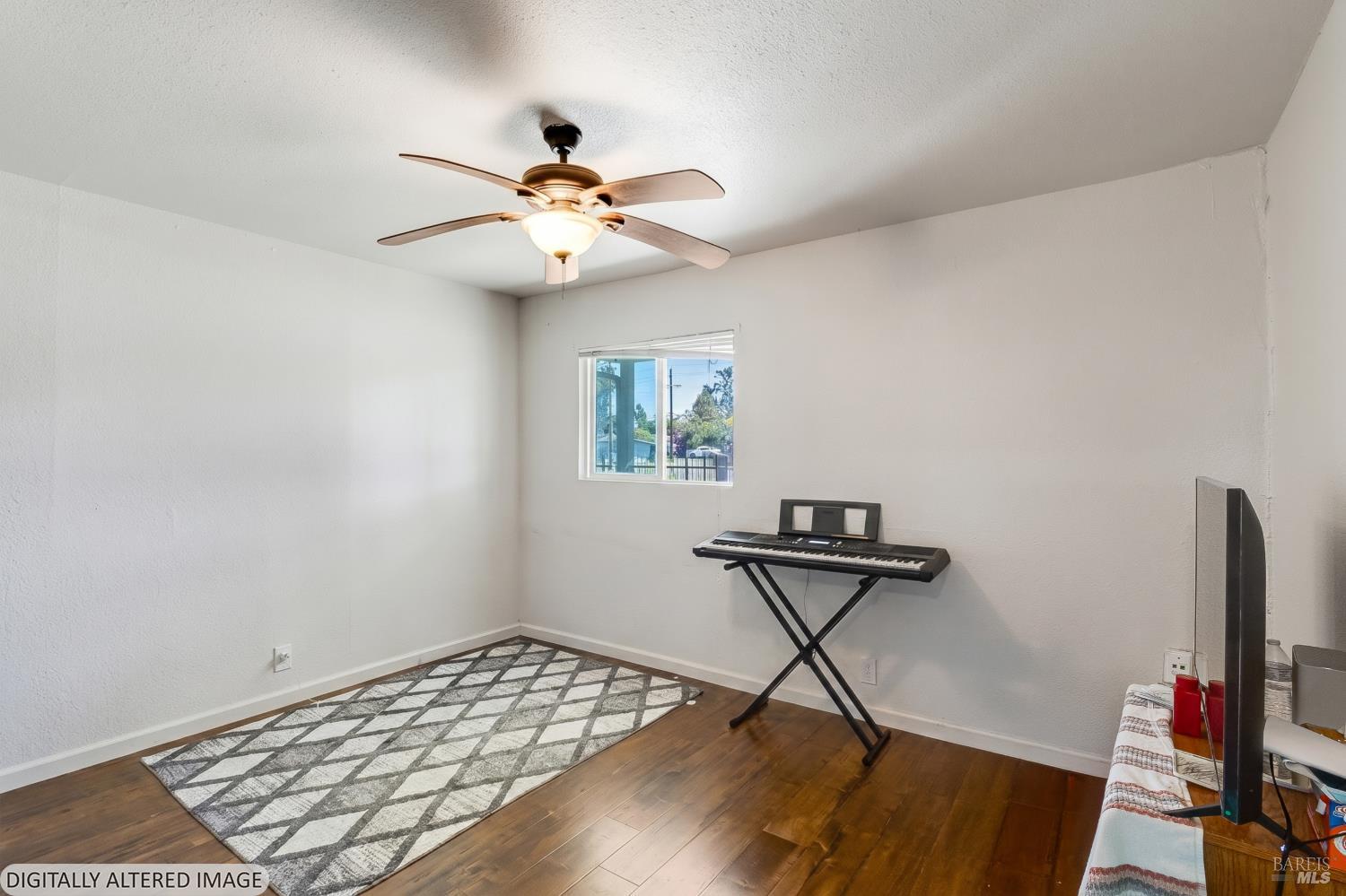 1722 Indiana Street Fairfield, CA 94533 - Photo 5 of 18 a view of workspace with wooden floor and fan