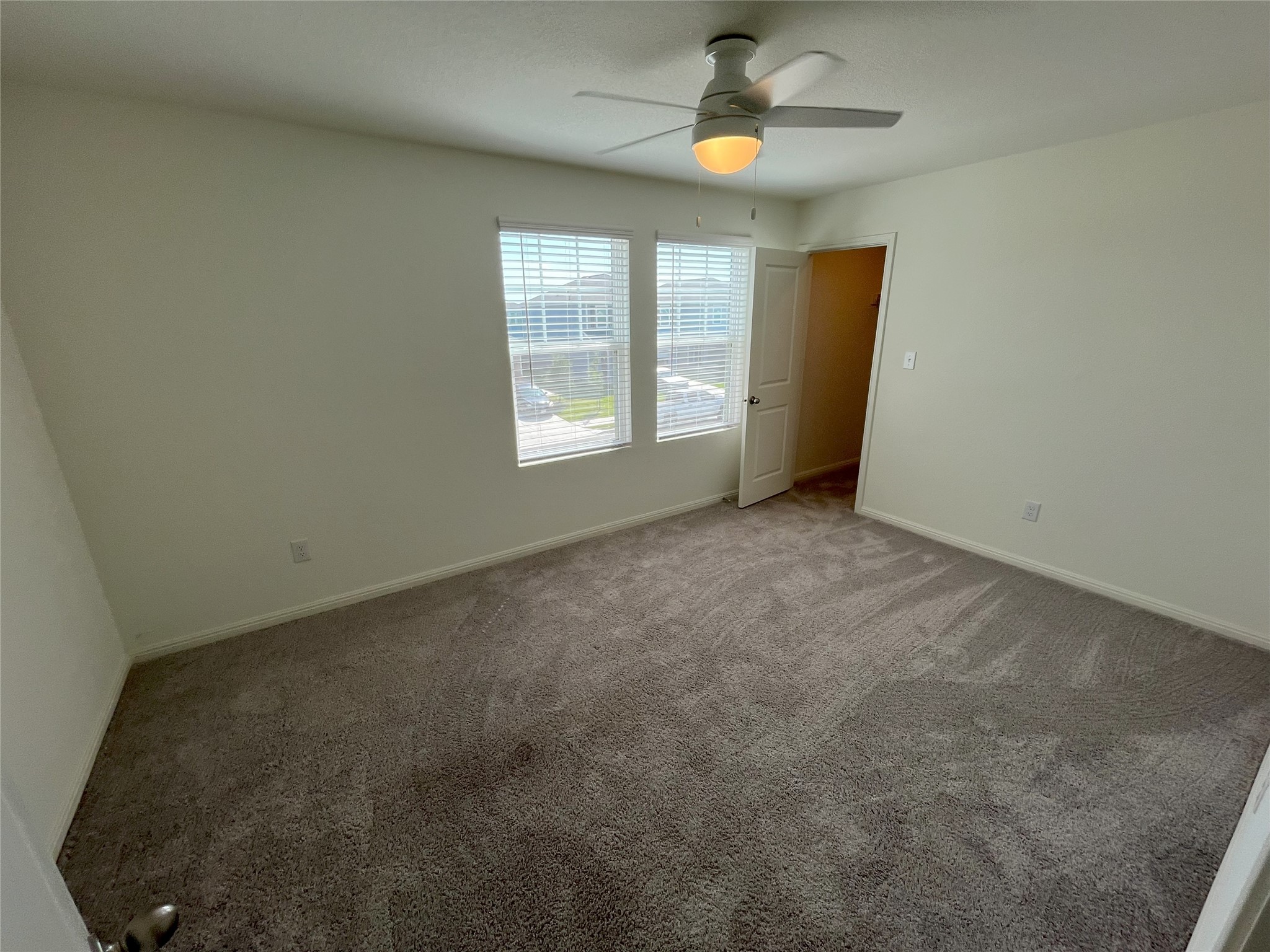215 Light Timber Road Maxwell, TX 78656 - Photo 17 of 33 Plush carpeting and dual windows illuminate this versatile secondary bedroom space.