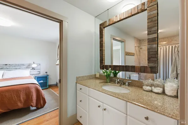a bedroom with a bed and windows
