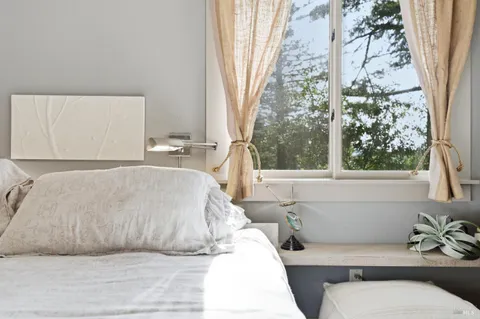 a spacious bedroom with a large bed and a couch