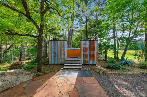a house view with a garden space and sitting area