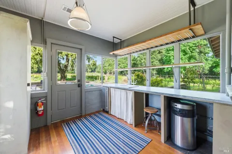 a kitchen with a stove and a wooden floors