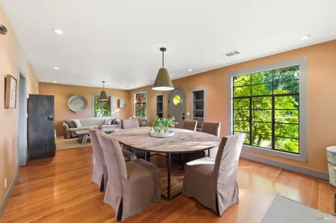 a view of a dining room with furniture and a window