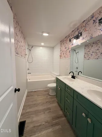 a bathroom with a double vanity sink toilet mirror and shower