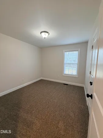 an empty room with a empty space and windows