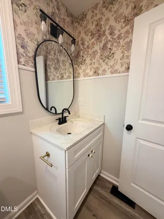 a bathroom with a sink and mirror