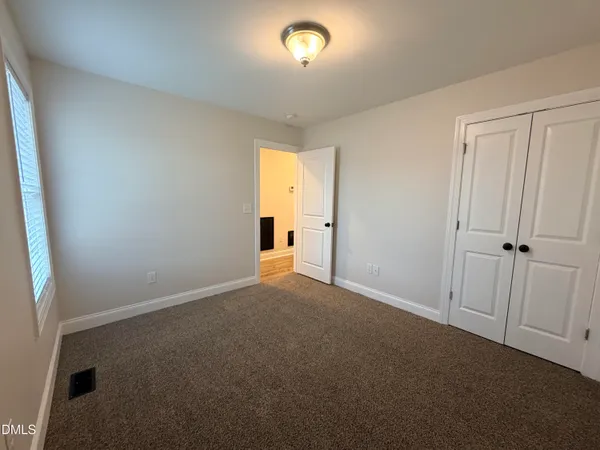 a view of an empty room and a window