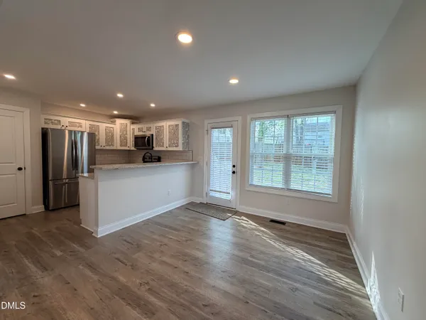 a view of a kitchen with a sink a refrigerator and window