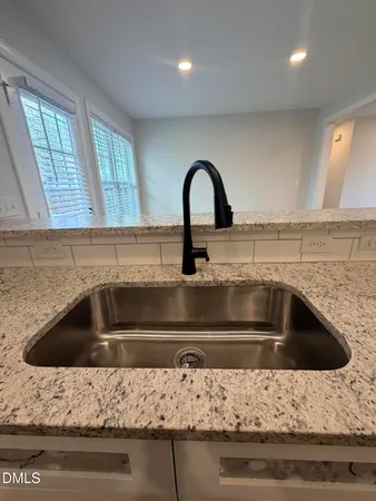 a kitchen with sink and window
