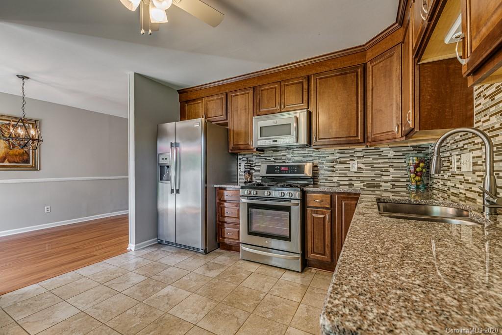 10125 Fairway Ridge Road Charlotte, NC 28277 - Photo 11 of 25 a kitchen with stainless steel appliances granite countertop a refrigerator stove and sink