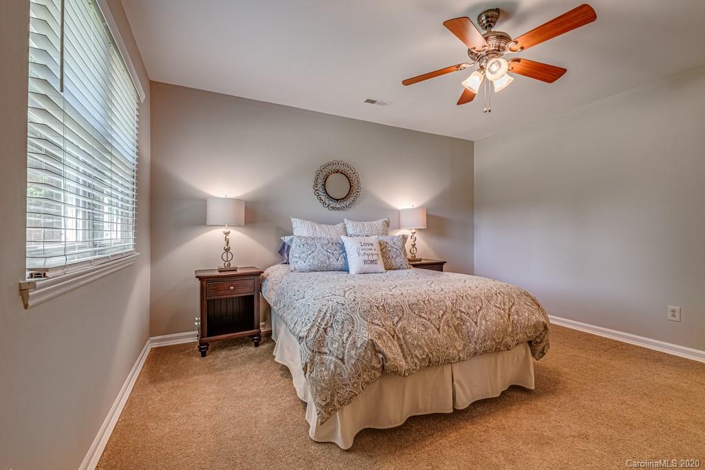 10125 Fairway Ridge Road Charlotte, NC 28277 - Photo 14 of 25 a bedroom with a bed and a chandelier
