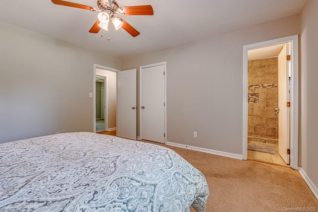 10125 Fairway Ridge Road Charlotte, NC 28277 - Photo 15 of 25 a bedroom with a bed and a chandelier fan