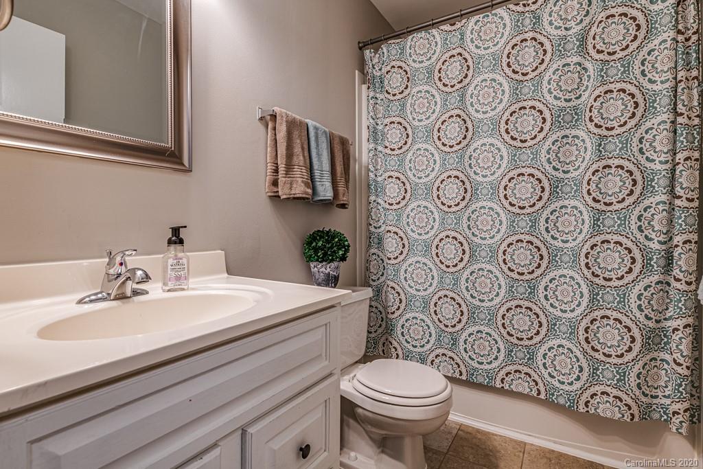 10125 Fairway Ridge Road Charlotte, NC 28277 - Photo 20 of 25 a bathroom with a toilet and sink with mirror