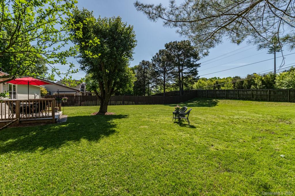 10125 Fairway Ridge Road Charlotte, NC 28277 - Photo 22 of 25 a view of a garden with a bench and trees
