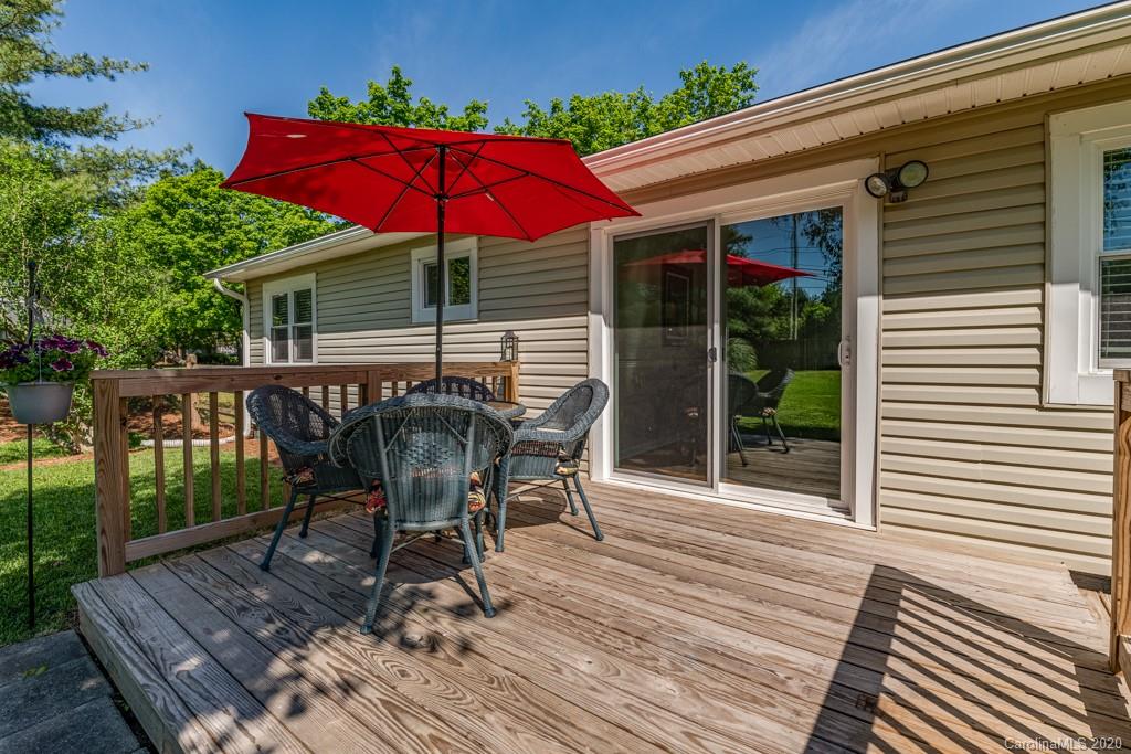 10125 Fairway Ridge Road Charlotte, NC 28277 - Photo 24 of 25 a patio with wooden floor a yard a table and chairs