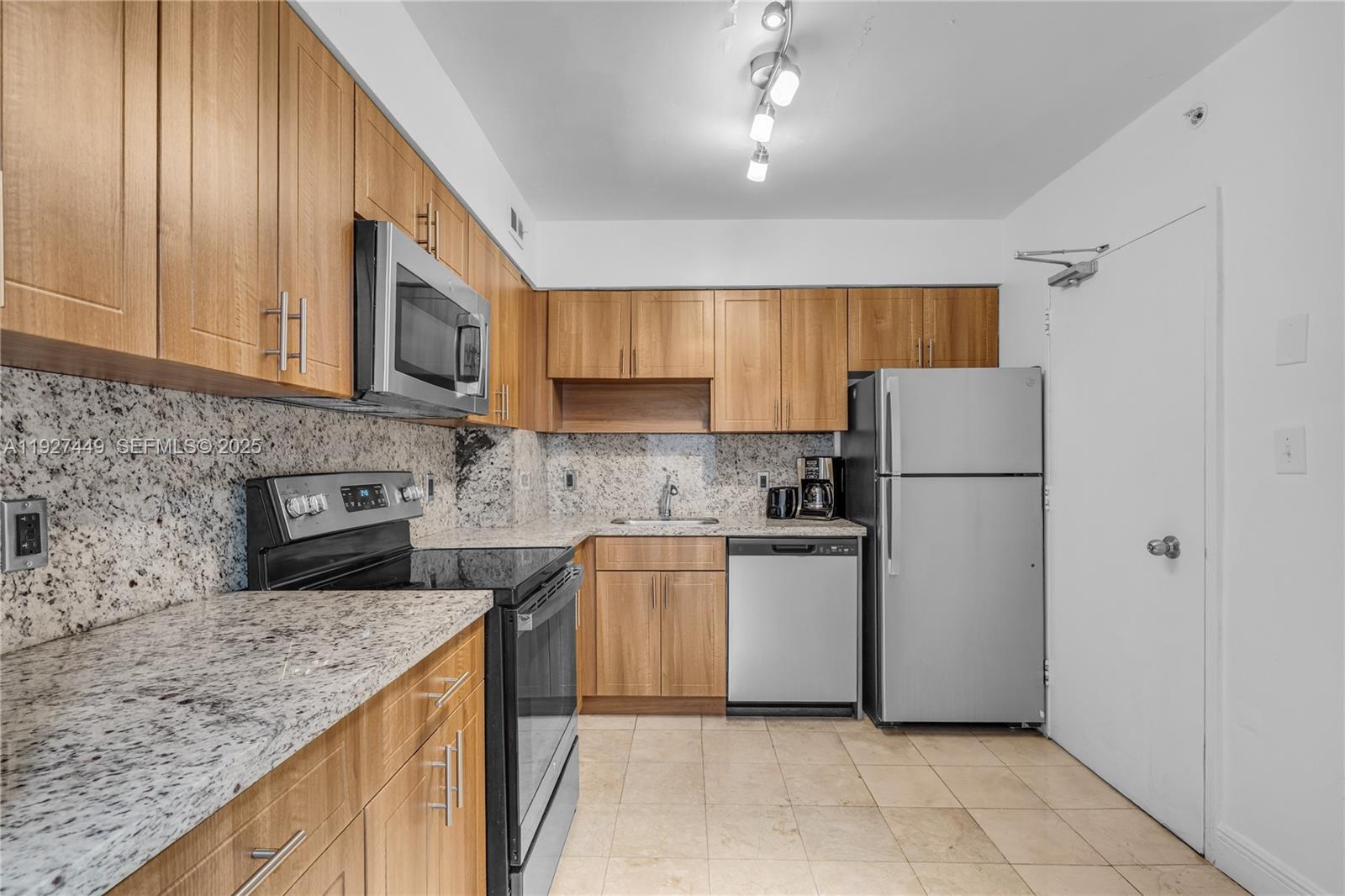 5101 Collins Avenue, Unit 12R Miami Beach, FL 33140 - Photo 3 of 13 a kitchen with a refrigerator sink and microwave