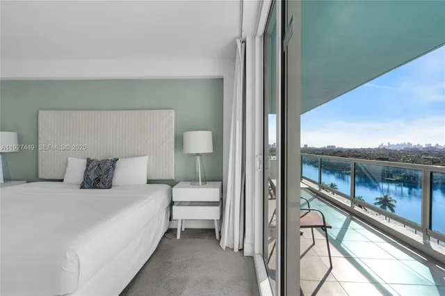 a bedroom with a bed and lamp with balcony view