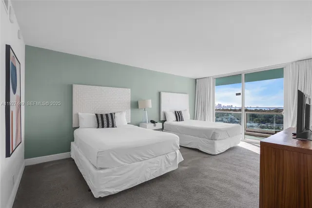 a bedroom with double bed and a large window