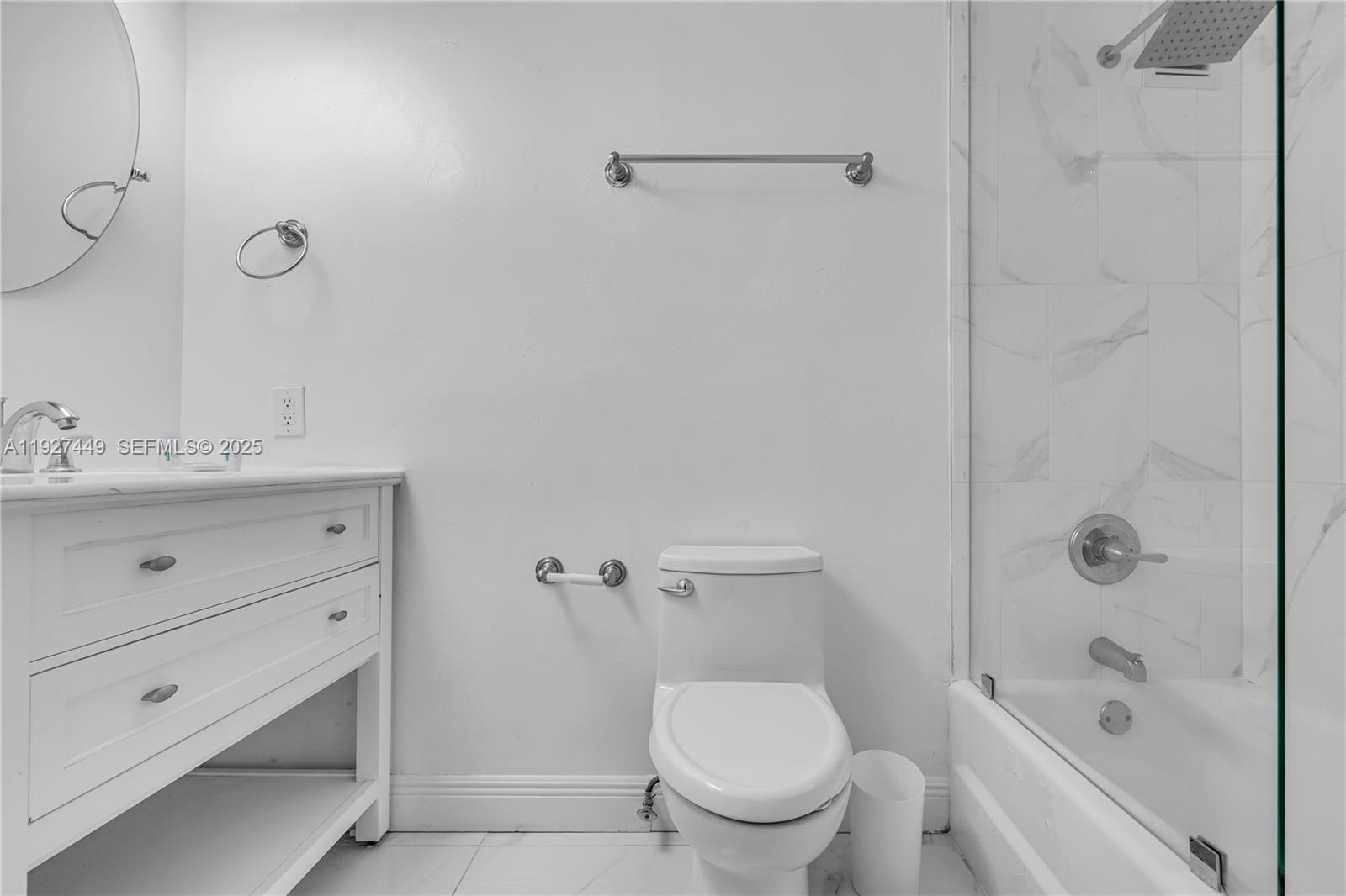 5101 Collins Avenue, Unit 12R Miami Beach, FL 33140 - Photo 8 of 13 a bathroom with a sink toilet and shower