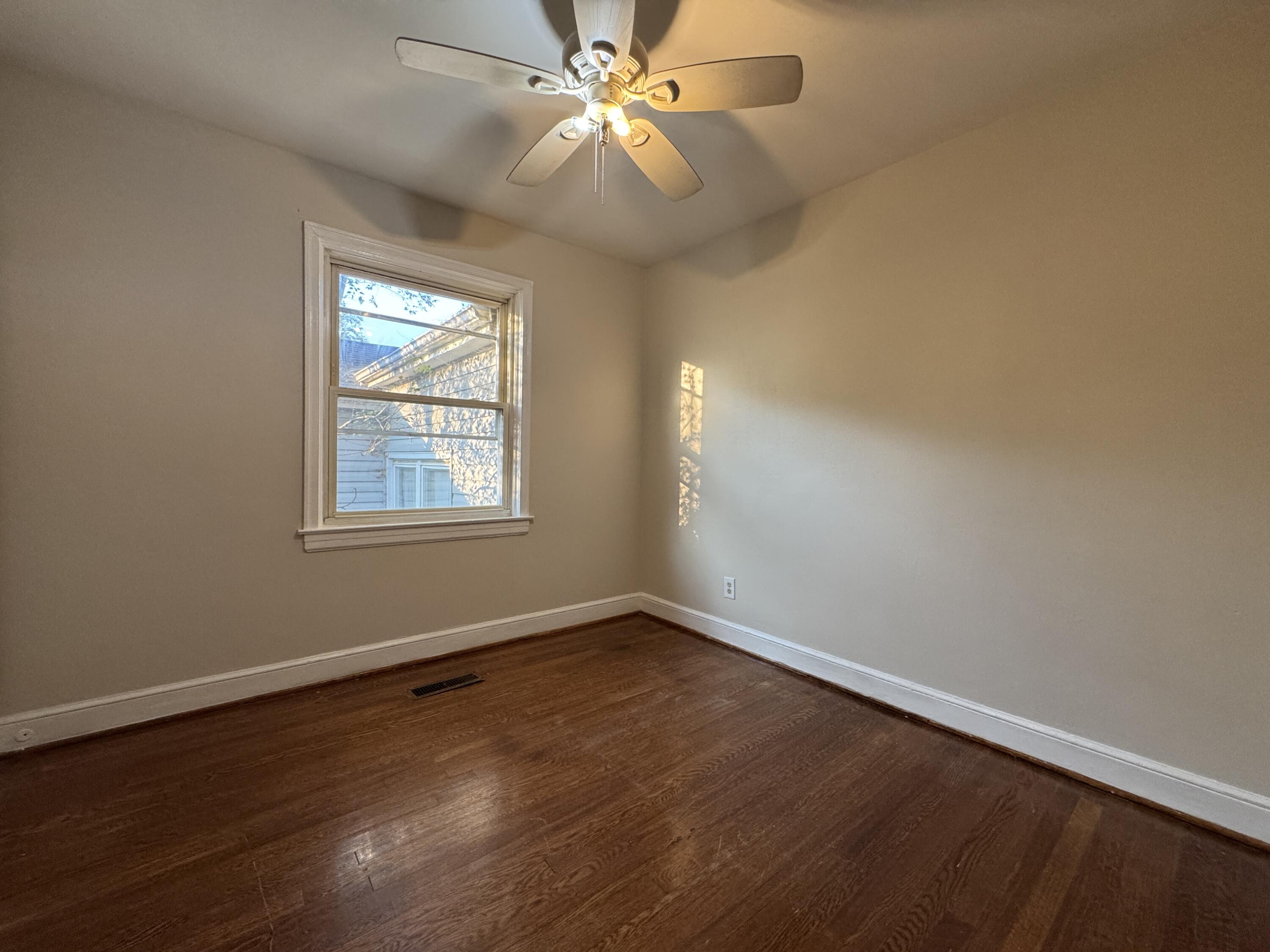 403 Liberty Road Northeast Roanoke, VA 24012 - Photo 12 of 20 wooden floor in an empty room with a window