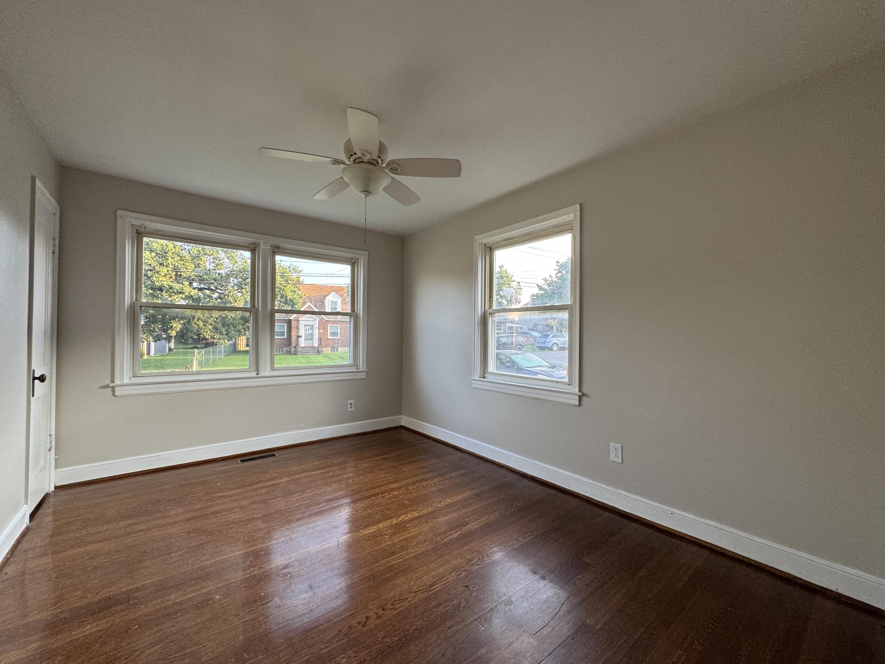403 Liberty Road Northeast Roanoke, VA 24012 - Photo 13 of 20 a view of an empty room with wooden floor and a window