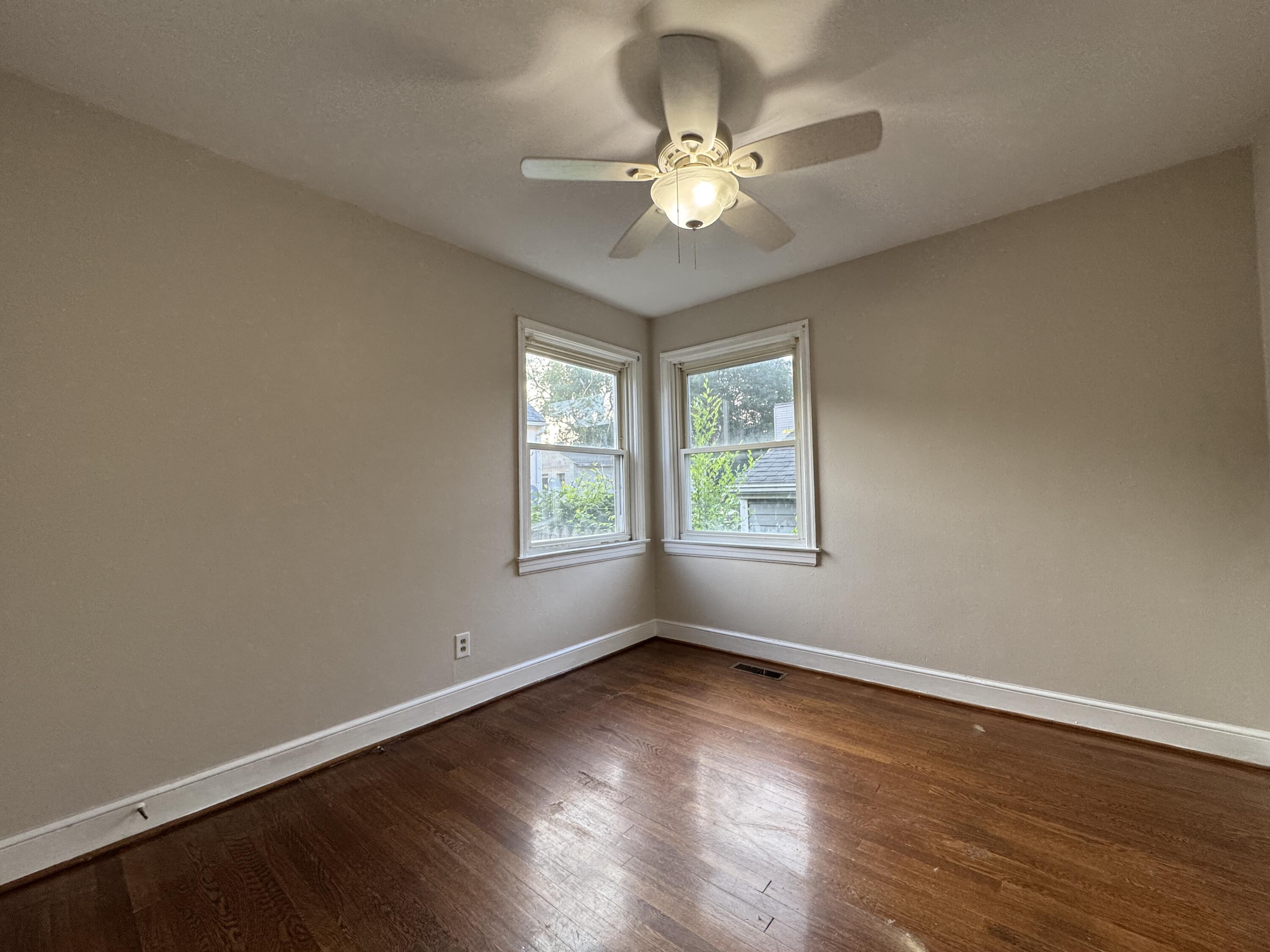 403 Liberty Road Northeast Roanoke, VA 24012 - Photo 14 of 20 a view of an empty room with wooden floor and a window