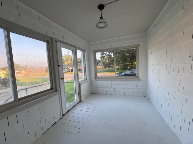 a view of an empty room with a fireplace