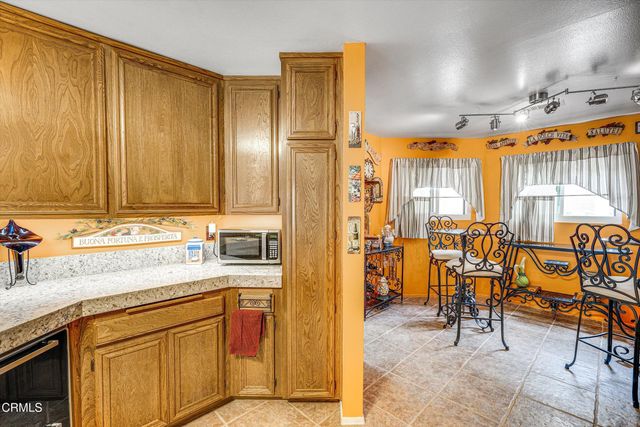 a kitchen with stainless steel appliances granite countertop a sink and cabinets