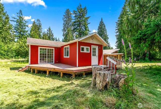 a front view of a house with a yard table and chairs